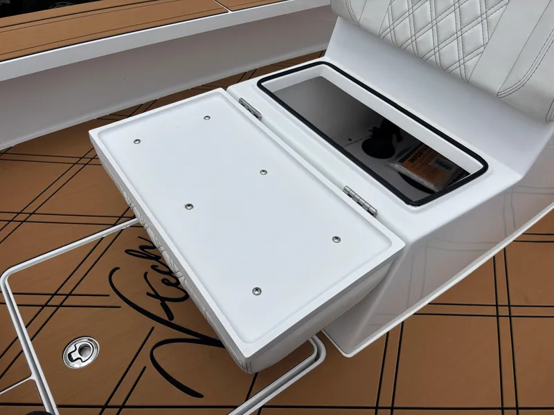 Slide: The Image of 2024 Vtech 18 FLATS boat seat with storage compartment, featuring sleek design and brown flooring. - 43