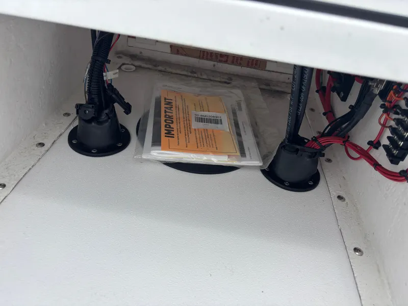 Slide: The Image of Interior view of a 2024 Vtech 18 FLATS with wiring and an important document packet. - 44