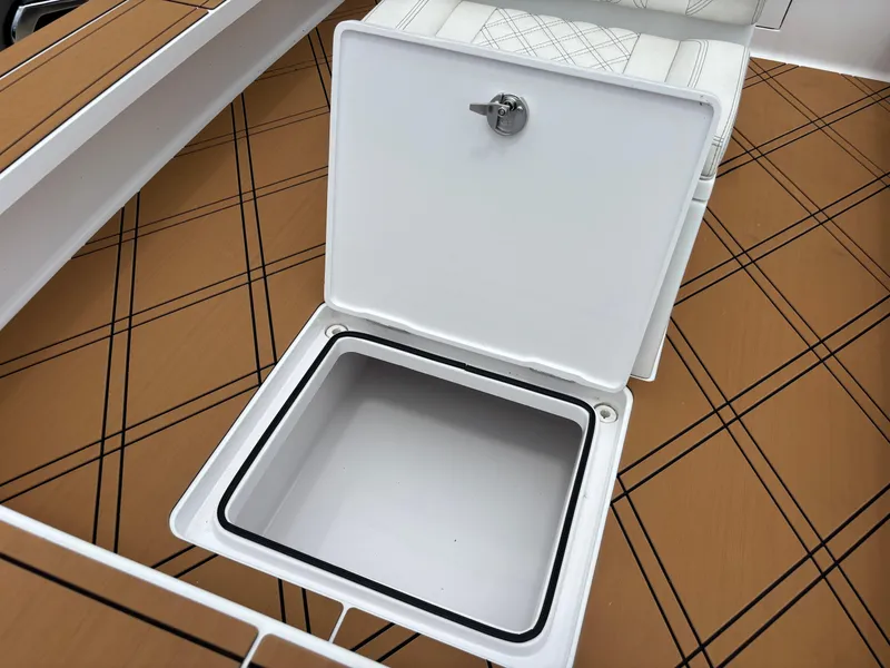 Slide: The Image of 2024 Vtech 18 FLATS boat storage compartment with open hatch on patterned deck. - 48