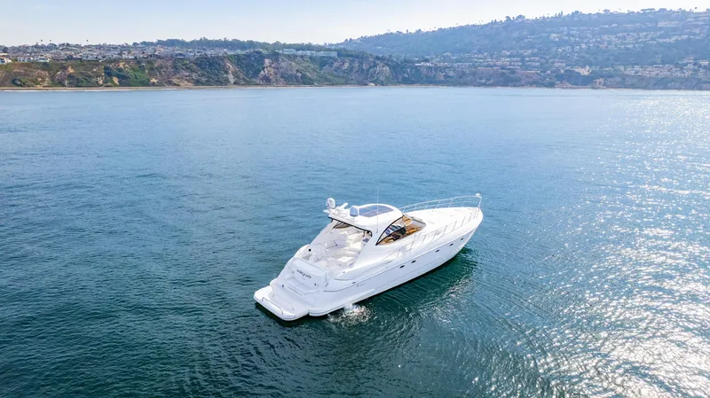 Slide: The Image of 2002 Cruisers Yachts 5370 Express on serene ocean waters. - 1