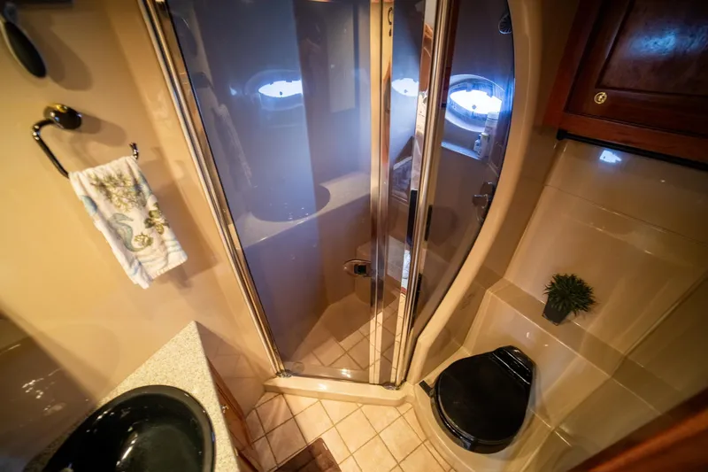 Slide: The Image of Luxurious bathroom in 2002 Cruisers Yachts 5370 Express with shower and modern fixtures. - 10