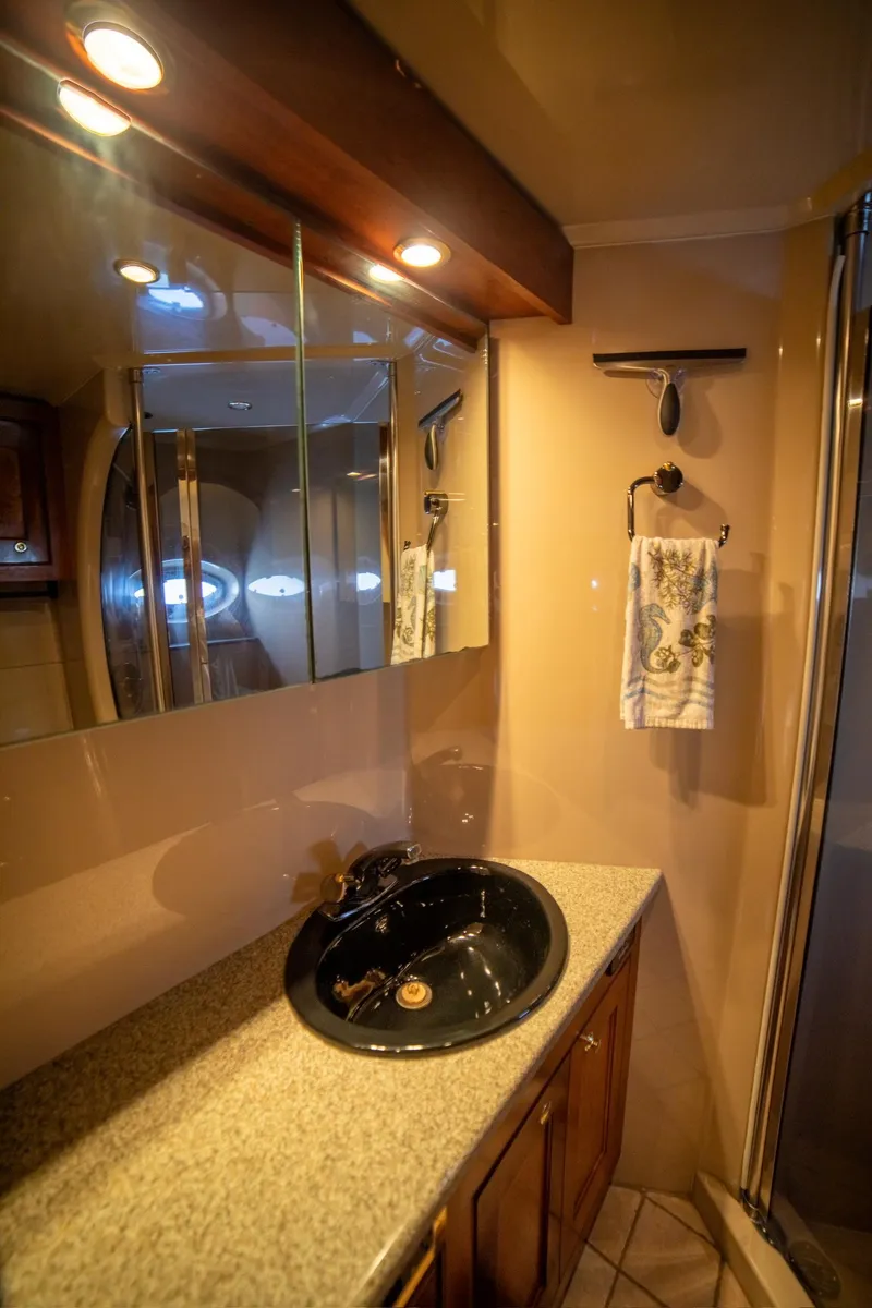 Slide: The Image of Luxurious bathroom in 2002 Cruisers Yachts 5370 Express with elegant fixtures and lighting. - 11