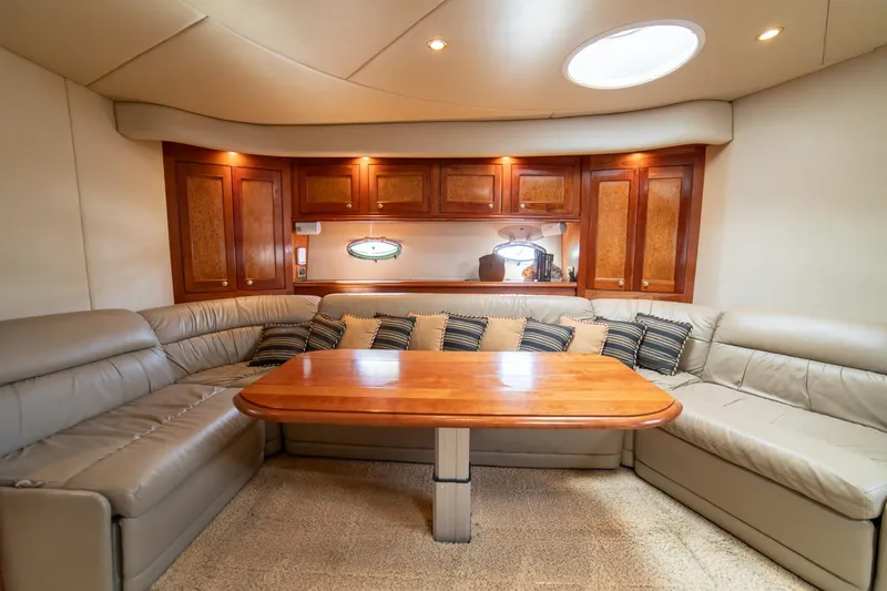 Slide: The Image of Luxurious interior of 2002 Cruisers Yachts 5370 Express with leather seating and wooden table. - 13