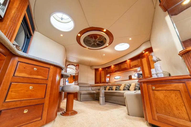 Slide: The Image of Luxurious interior of 2002 Cruisers Yachts 5370 Express with elegant wood cabinetry and plush seating. - 14