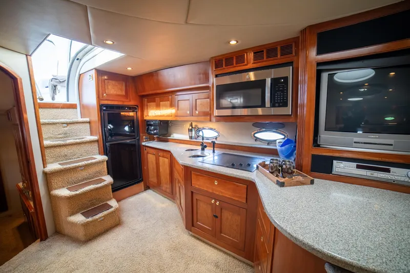 Slide: The Image of Luxurious 2002 Cruisers Yachts 5370 Express interior with modern kitchen amenities. - 15