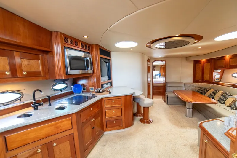 Slide: The Image of Luxurious interior of 2002 Cruisers Yachts 5370 Express with kitchen and seating area. - 16
