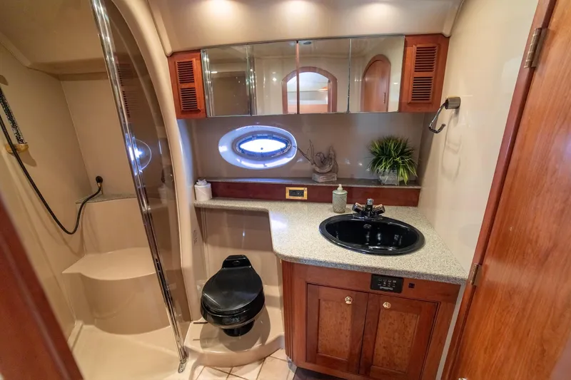 Slide: The Image of Luxurious bathroom in 2002 Cruisers Yachts 5370 Express with modern fixtures and elegant design. - 18