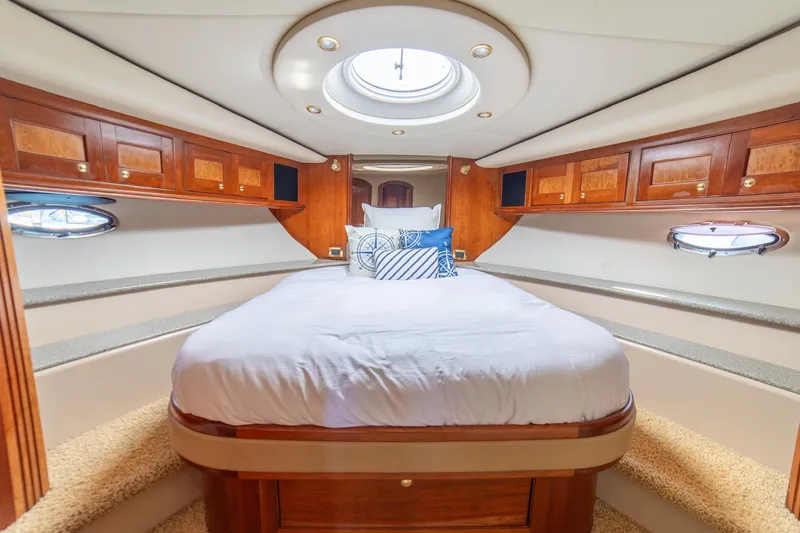 Slide: The Image of Luxurious cabin interior of 2002 Cruisers Yachts 5370 Express with elegant wood finish. - 21