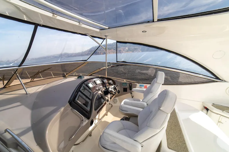 Slide: The Image of Interior view of 2002 Cruisers Yachts 5370 Express cockpit with dual seats and control panel. - 5