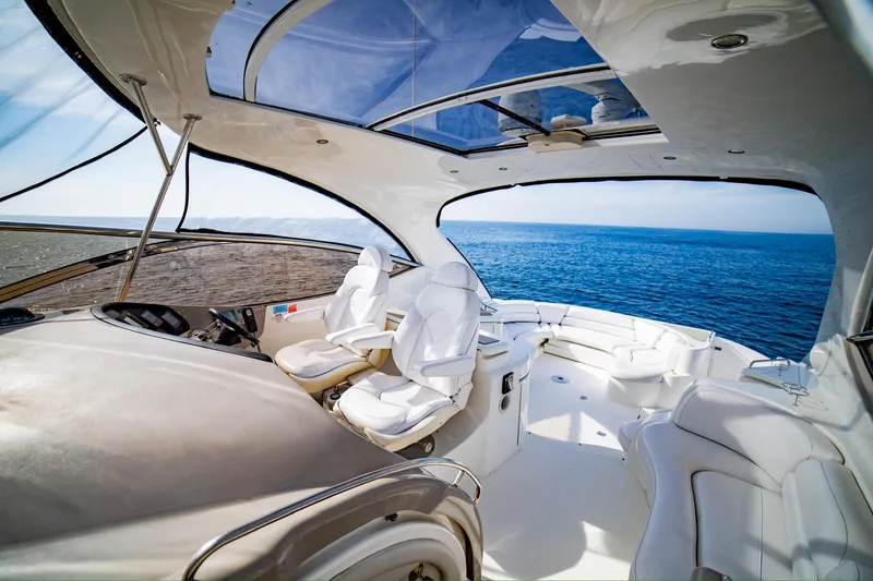 Slide: The Image of Luxurious 2002 Cruisers Yachts 5370 Express interior with ocean view and plush seating. - 6