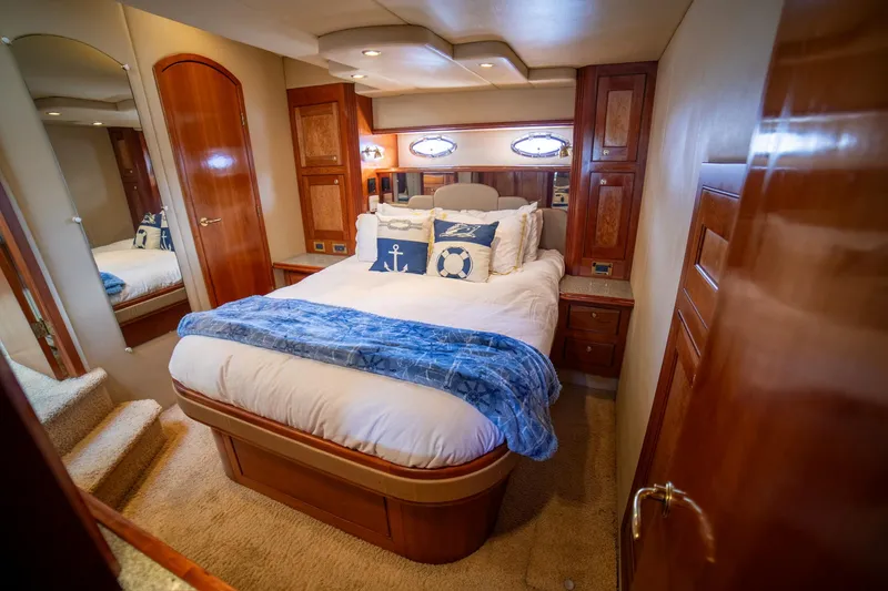 Slide: The Image of Luxurious bedroom interior of 2002 Cruisers Yachts 5370 Express with nautical decor. - 9