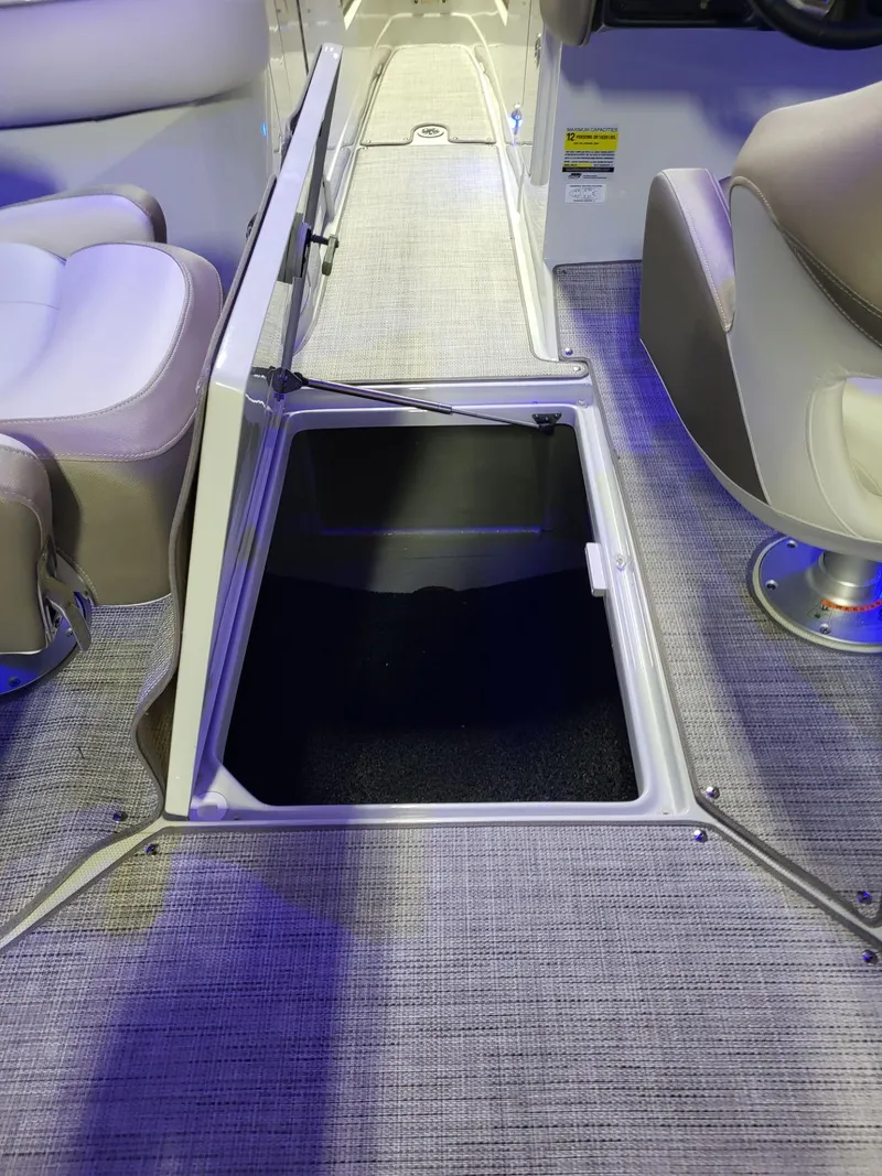 Slide: The Image of 2023 Crownline 260 SS boat interior with open storage compartment. - 11