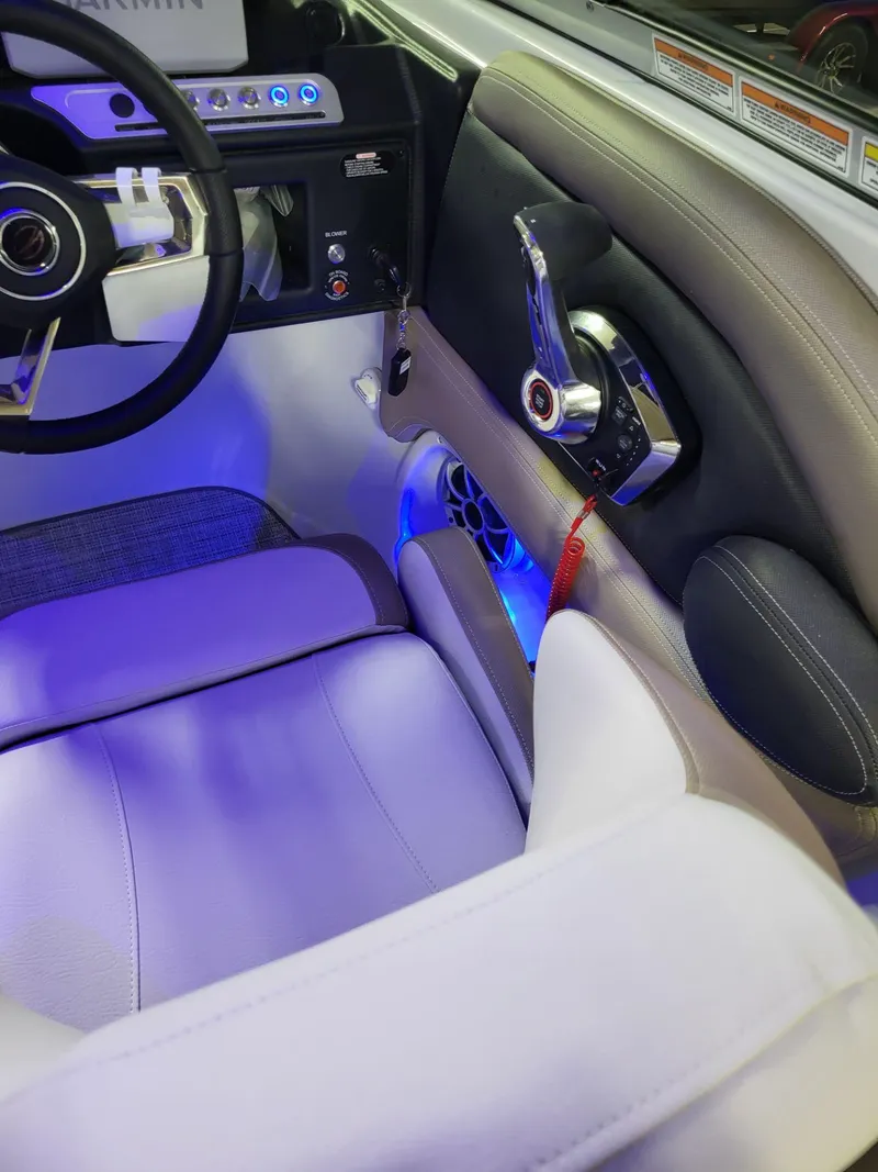 Slide: The Image of 2023 Crownline 260 SS boat interior with modern controls and ambient lighting. - 12