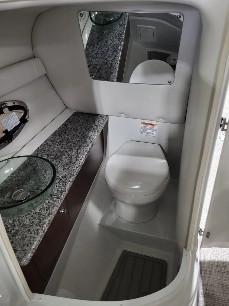 Slide: The Image of 2023 Crownline 260 SS boat bathroom with modern fixtures and granite countertop. - 14