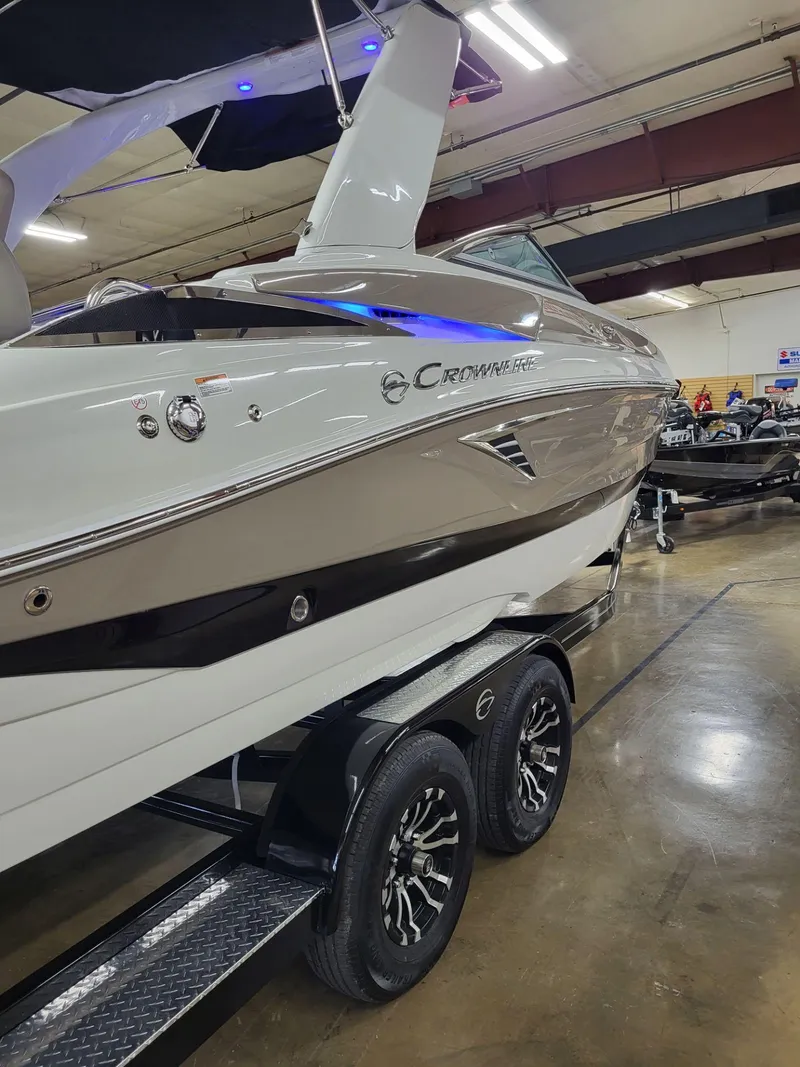 Slide: The Image of 2023 Crownline 260 SS boat on trailer in indoor showroom. - 17