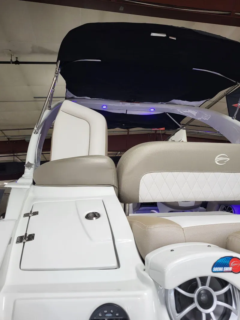 Slide: The Image of 2023 Crownline 260 SS boat interior with beige seating and modern design. - 18