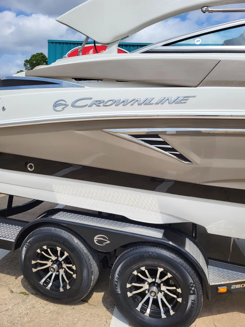 Slide: The Image of 2023 Crownline 260 SS boat on trailer, showcasing sleek design and modern features. - 2