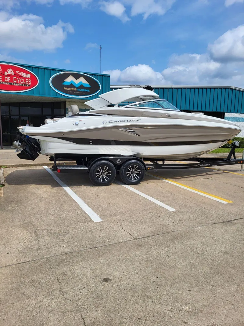 Slide: The Image of 2023 Crownline 260 SS boat on trailer, parked outside dealership. - 3