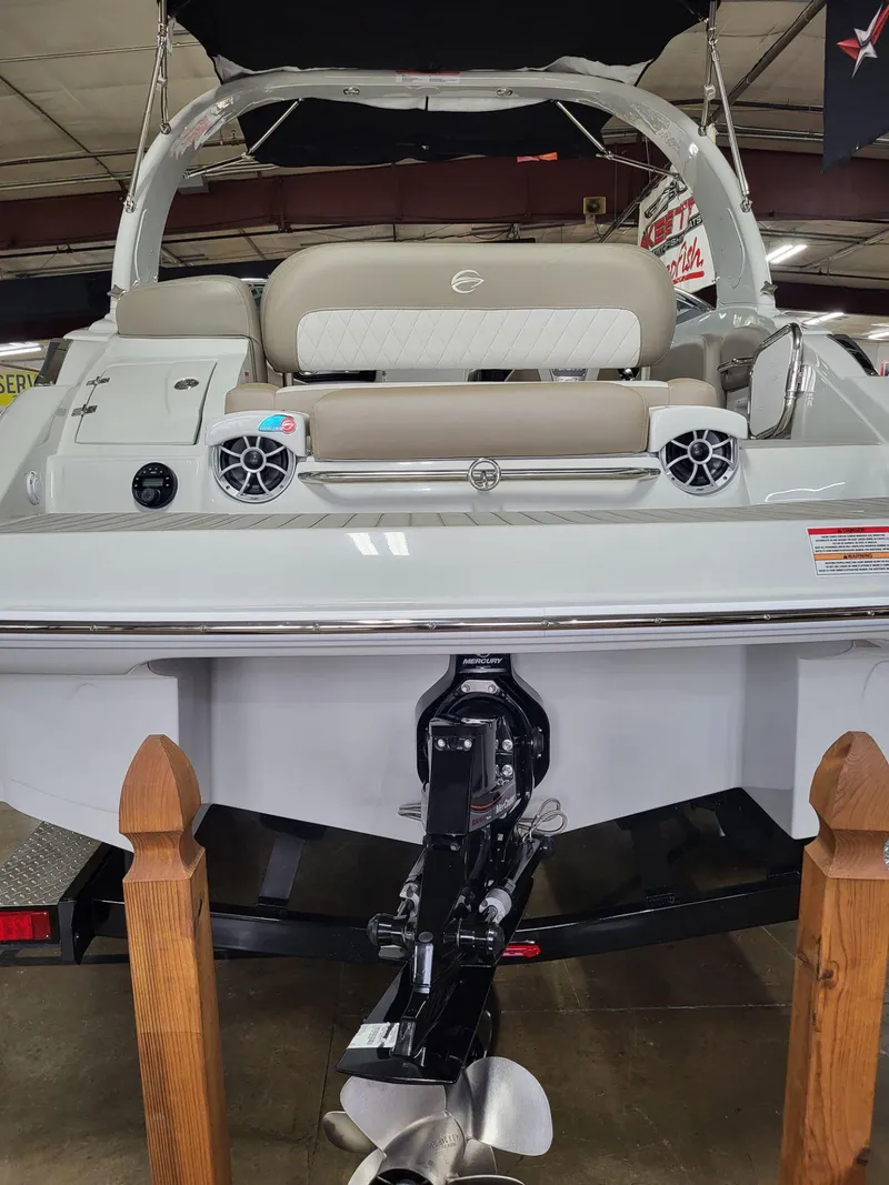 Slide: The Image of 2023 Crownline 260 SS boat, rear view, showcasing sleek design and powerful engine. - 4
