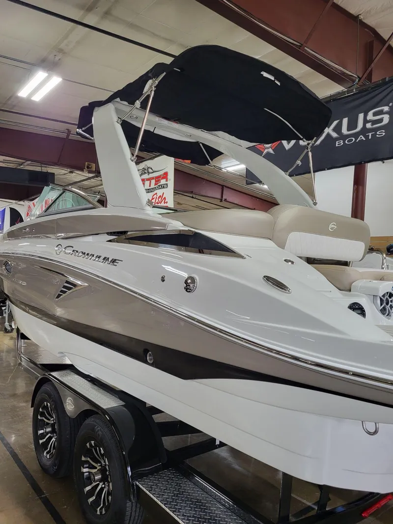 Slide: The Image of 2023 Crownline 260 SS boat displayed indoors on a trailer. - 5