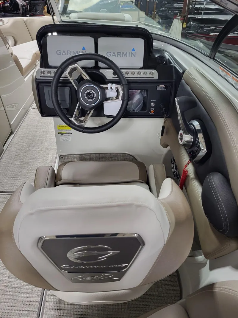 Slide: The Image of 2023 Crownline 260 SS boat cockpit with Garmin navigation system and steering wheel. - 7