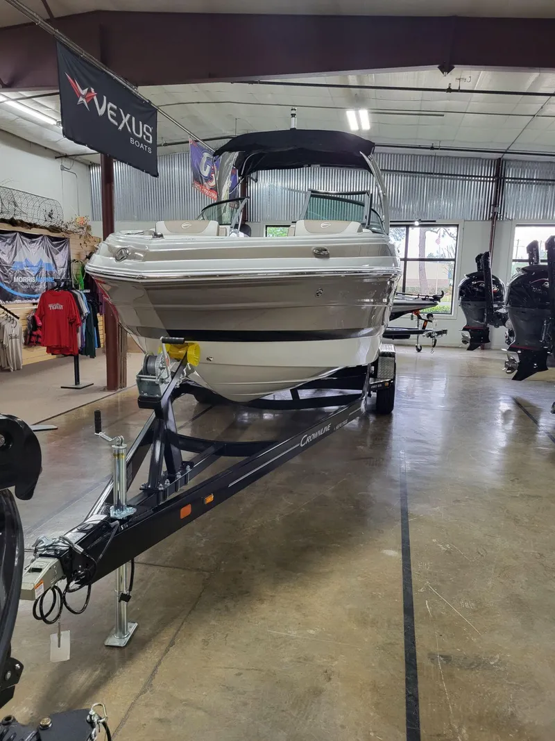 Slide: The Image of 2023 Crownline 260 SS boat on trailer in showroom. - 8