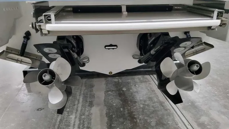 Slide: The Image of 2025 Formula 330 Crossover Bowrider dual propellers in a garage setting. - 11