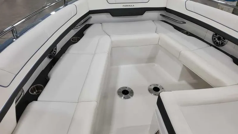 Slide: The Image of 2025 Formula 330 Crossover Bowrider interior with spacious white seating and cup holders. - 13