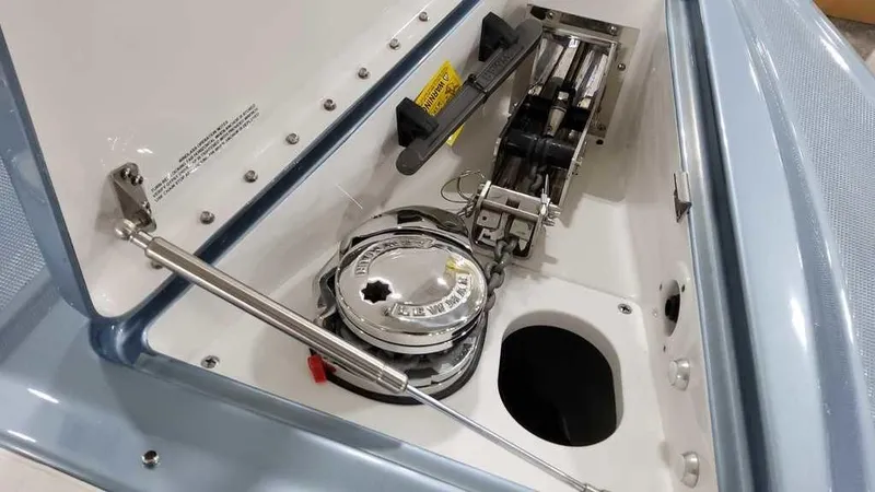 Slide: The Image of 2025 Formula 330 Crossover Bowrider anchor compartment with winch system. - 15