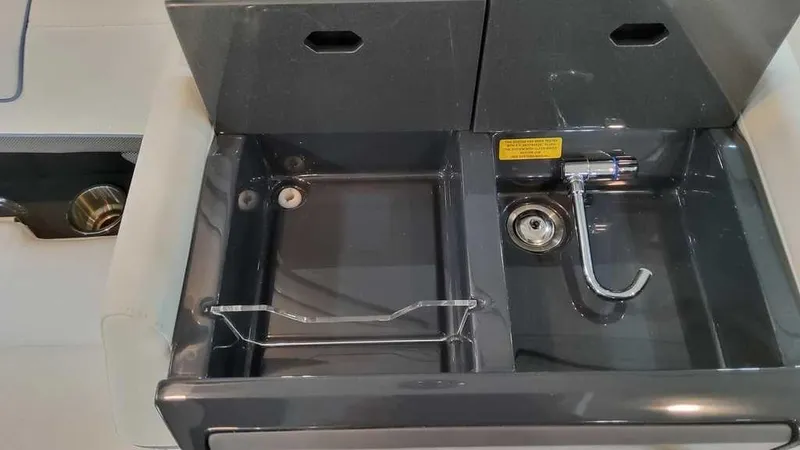 Slide: The Image of 2025 Formula 330 Crossover Bowrider sink area with modern fixtures and storage compartments. - 18