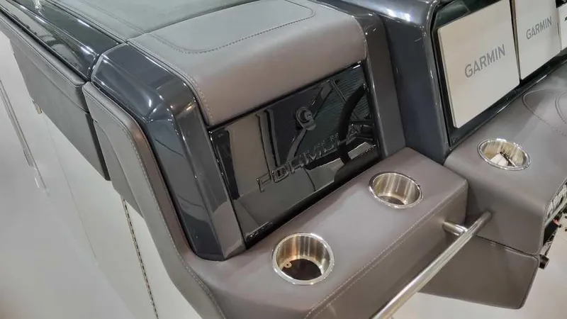 Slide: The Image of 2025 Formula 330 Crossover Bowrider dashboard with Garmin displays and cup holders. - 21