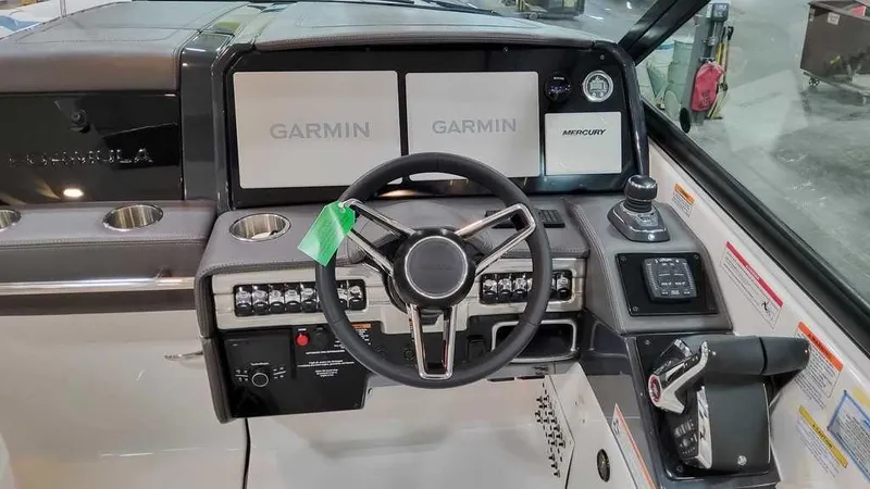 Slide: The Image of 2025 Formula 330 Crossover Bowrider dashboard with Garmin displays and steering wheel. - 22