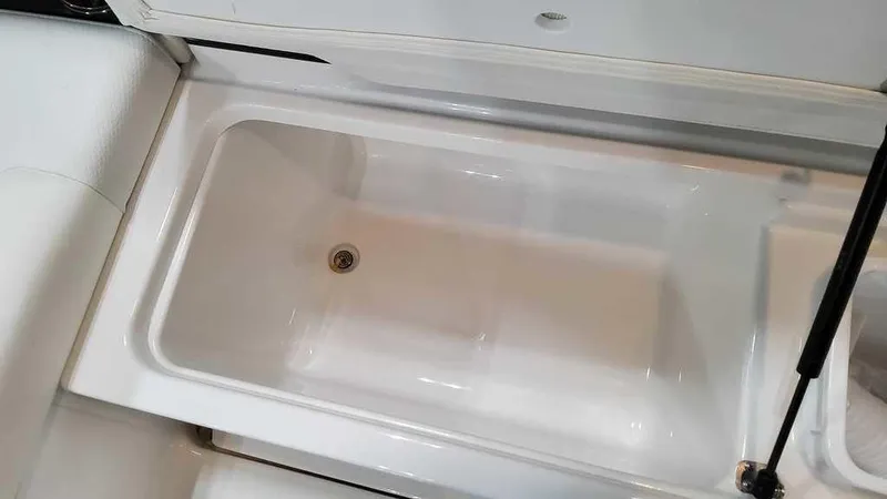 Slide: The Image of 2025 Formula 330 Crossover Bowrider storage compartment, open and empty. - 25