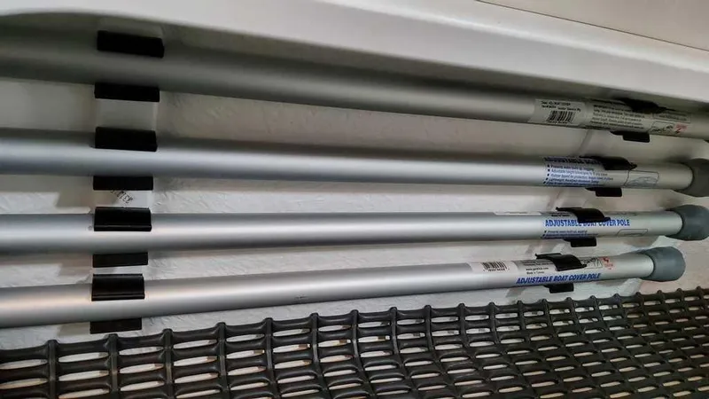 Slide: The Image of Storage compartment with metal rods in 2025 Formula 330 Crossover Bowrider. - 26