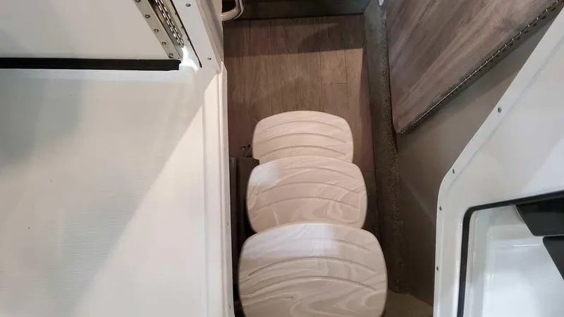 Slide: The Image of Interior view of 2025 Formula 330 Crossover Bowrider with wooden flooring and seating. - 27