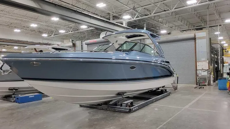 Slide: The Image of 2025 Formula 330 Crossover Bowrider in a showroom, showcasing sleek design and modern features. - 3