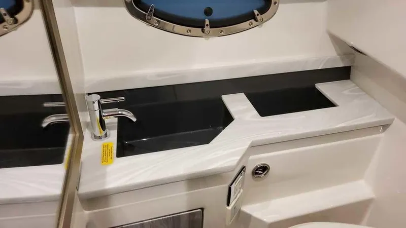 Slide: The Image of Interior of 2025 Formula 330 Crossover Bowrider, featuring a sleek sink and faucet design. - 31