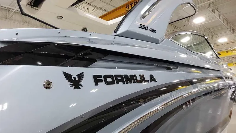 Slide: The Image of 2025 Formula 330 Crossover Bowrider boat, sleek design, showroom display. - 4