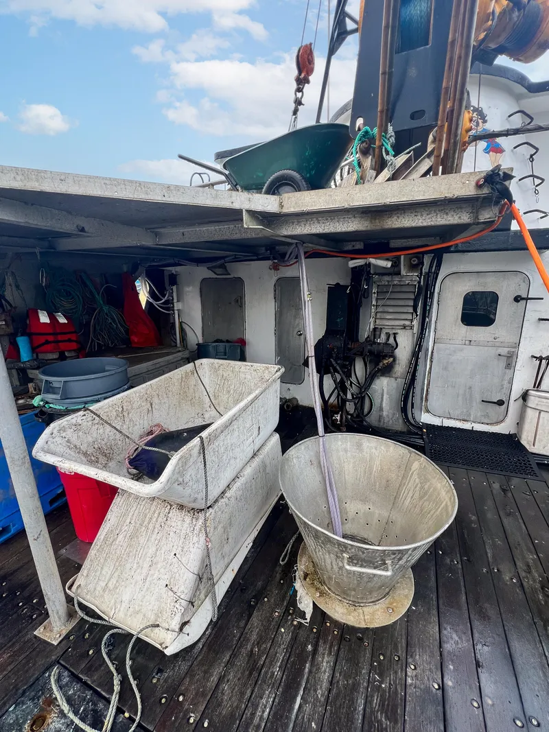 Slide: The Image of 1980 custom fishing vessel deck with equipment and storage containers. - 14