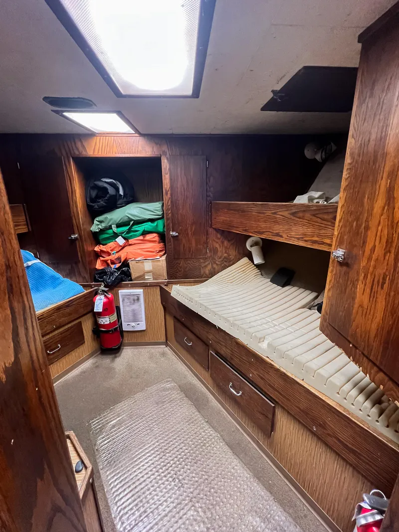 Slide: The Image of Cozy cabin interior of a 1980 custom fishing vessel with wooden furnishings and storage. - 9