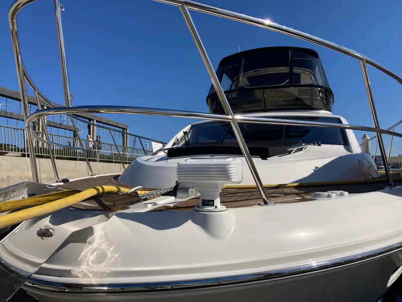 Slide: The Image of 2018 Sea Ray Fly 510 yacht docked under clear blue sky. - 12