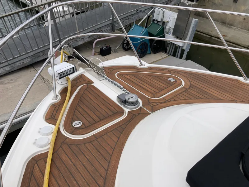 Slide: The Image of 2018 Sea Ray Fly 510 yacht deck with teak flooring and railing. - 17