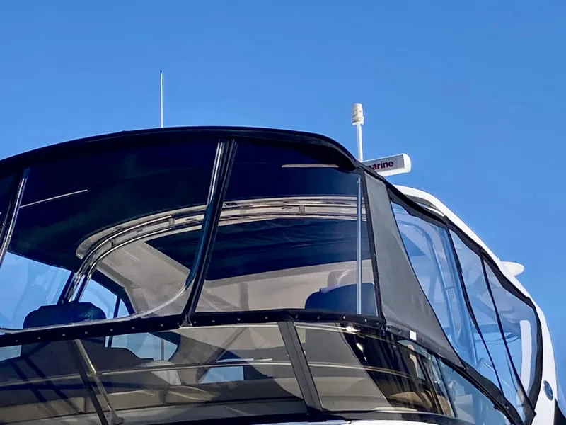 Slide: The Image of 2018 Sea Ray Fly 510 yacht with sleek design against clear blue sky. - 21