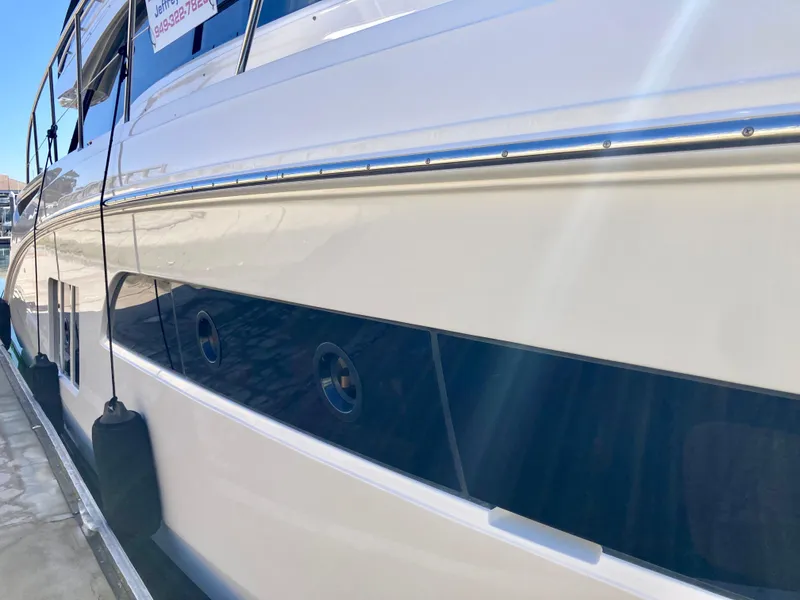 Slide: The Image of 2018 Sea Ray Fly 510 yacht docked, showcasing sleek design and polished exterior. - 27