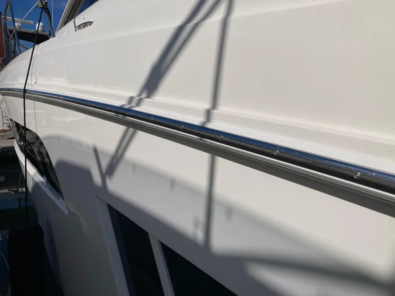 Slide: The Image of 2018 Sea Ray Fly 510 yacht side view with sleek white exterior. - 28