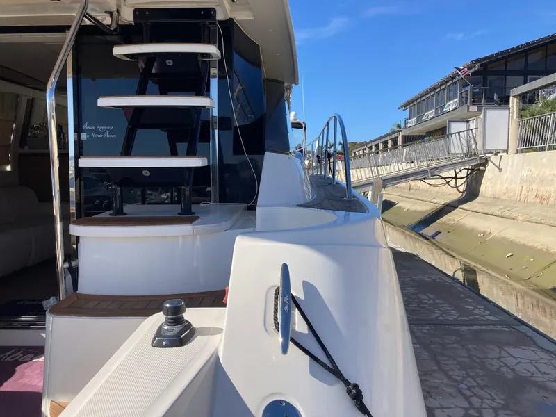 Slide: The Image of 2018 Sea Ray Fly 510 yacht docked, showcasing sleek design and modern features. - 35