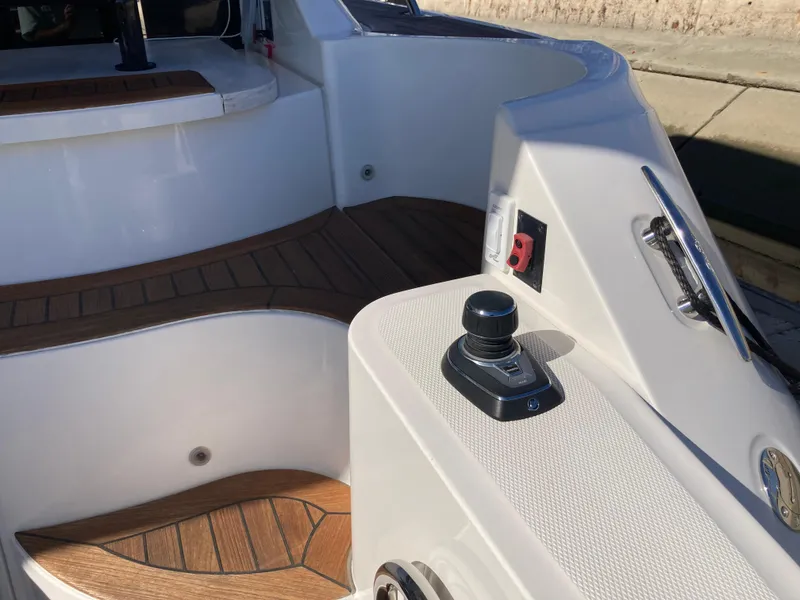 Slide: The Image of 2018 Sea Ray Fly 510 yacht deck with joystick control and wood flooring. - 37
