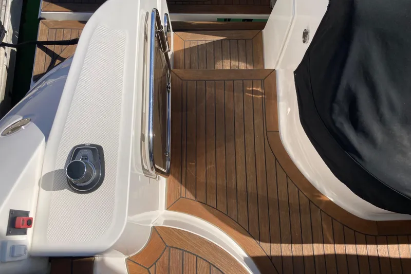 Slide: The Image of 2018 Sea Ray Fly 510 yacht deck with wood finish and control panel. - 38