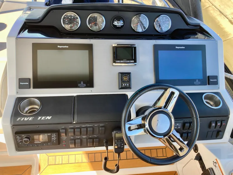 Slide: The Image of 2018 Sea Ray Fly 510 helm with dual Raymarine displays and modern controls. - 48