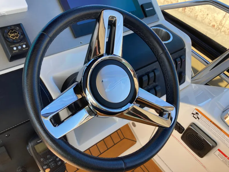 Slide: The Image of Steering wheel of 2018 Sea Ray Fly 510 yacht, featuring modern controls and sleek design. - 49